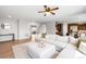 Spacious living room with hardwood floors and seamless flow into kitchen at 17378 W 78Th Dr, Arvada, CO 80007