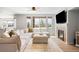 Comfortable living room boasts a cozy fireplace, and many windows for natural light at 17378 W 78Th Dr, Arvada, CO 80007