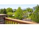 Overlooking a well-manicured backyard with mature trees, fencing, and play equipment at 17378 W 78Th Dr, Arvada, CO 80007