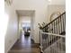 Inviting foyer with hardwood floors, staircase, and views of the front living area through large windows at 10962 Vaughn St, Commerce City, CO 80022