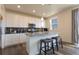 Kitchen featuring white cabinets, stainless steel appliances, and a granite-topped island with bar stool seating at 10962 Vaughn St, Commerce City, CO 80022