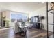 Bright living room featuring hardwood floors, large windows, and contemporary decor at 10962 Vaughn St, Commerce City, CO 80022