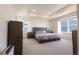 Spacious main bedroom with large windows and a tray ceiling at 10962 Vaughn St, Commerce City, CO 80022