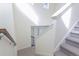 Carpeted staircase with white railings and natural light coming from upper windows at 10962 Vaughn St, Commerce City, CO 80022