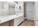 Neutral bathroom featuring a wide vanity, tiled shower, and a bright, clean aesthetic at 7434 Singing Hills Ct, Boulder, CO 80301