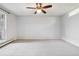 Spacious bedroom featuring a ceiling fan and a large window at 7434 Singing Hills Ct, Boulder, CO 80301