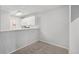 Cozy dining area features a small kitchen, white cabinets, and an open layout with space for a table at 7434 Singing Hills Ct, Boulder, CO 80301