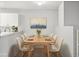 Bright dining room with modern table, seating for eight, and stylish decor featuring an artful painting at 7434 Singing Hills Ct, Boulder, CO 80301