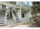 Charming exterior elevation showcases gray wood paneling and well-maintained stairs leading to cozy, upper-level units at 7434 Singing Hills Ct, Boulder, CO 80301