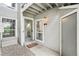 Inviting entrance features a glass door, warm lighting, and a 'Welcome' mat, creating a friendly and charming entryway at 7434 Singing Hills Ct, Boulder, CO 80301