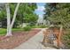 Scenic view of tree-lined walkways and manicured lawns with benches throughout the community at 7434 Singing Hills Ct, Boulder, CO 80301
