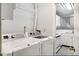 Functional laundry room adjacent to the kitchen, featuring modern washer and dryer units at 7434 Singing Hills Ct, Boulder, CO 80301