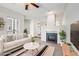 Inviting living room features a cozy fireplace and stylish decor with a comfortable white couch and modern accents at 7434 Singing Hills Ct, Boulder, CO 80301