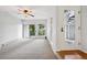 Living room featuring a sliding glass door, large window, and front door at 7434 Singing Hills Ct, Boulder, CO 80301