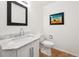 Bathroom features a marble sink, neutral paint, framed mirror, and picture at 10166 Grove Loop # D, Westminster, CO 80031