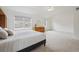 Spacious bedroom includes carpet, wooden dresser, ceiling fan with light and window views at 10166 Grove Loop # D, Westminster, CO 80031
