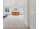 Large bright room with carpet, windows, light walls and wooden dresser at 10166 Grove Loop # D, Westminster, CO 80031