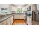 Kitchen features white cabinets, granite countertops, and stainless steel appliances at 10166 Grove Loop # D, Westminster, CO 80031