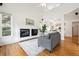Bright living room with a cozy fireplace and hardwood floors at 10166 Grove Loop # D, Westminster, CO 80031