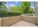 Private outdoor patio space with partial wooden fence and privacy hedge at 10166 Grove Loop # D, Westminster, CO 80031