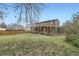 Large grassy backyard with a wooden fence and covered deck at 11864 E Idaho Dr, Aurora, CO 80012