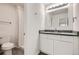 Updated bathroom boasts a modern vanity, white subway tile shower, and toilet at 11864 E Idaho Dr, Aurora, CO 80012