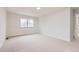 Bright bedroom featuring neutral carpet, a window, and a ceiling light at 11864 E Idaho Dr, Aurora, CO 80012