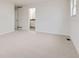 Spacious bedroom with neutral carpet and a door to an en-suite bathroom at 11864 E Idaho Dr, Aurora, CO 80012