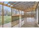Covered patio area looking out to the backyard with a wooden lattice divider and playset at 11864 E Idaho Dr, Aurora, CO 80012