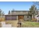 Charming two-story home with a well-manicured lawn, complemented by a spacious three-car garage at 11864 E Idaho Dr, Aurora, CO 80012