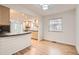 Bright kitchen and dining area featuring hardwood floors and a breakfast bar at 11864 E Idaho Dr, Aurora, CO 80012