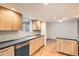 Kitchen with wood cabinets, dark countertops, and hardwood floors at 11864 E Idaho Dr, Aurora, CO 80012