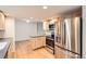 Bright kitchen features stainless appliances, wood cabinets, and hardwood floors at 11864 E Idaho Dr, Aurora, CO 80012
