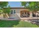 Relaxing outdoor patio area with a covered porch and mature green trees surrounding the back yard at 8582 E 148Th Ln, Thornton, CO 80602