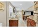 Finished basement featuring an entertainment bar, a sink, wood cabinets, and seating at 8582 E 148Th Ln, Thornton, CO 80602