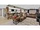 Finished basement with a stone bar, multiple seating areas, and entertainment options for a relaxed atmosphere at 8582 E 148Th Ln, Thornton, CO 80602