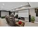 Finished basement with comfortable seating, a theater screen, and stylish decor for entertainment at 8582 E 148Th Ln, Thornton, CO 80602