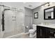 Modern bathroom features a glass enclosed shower with marble tiling and vanity with a black cabinet at 8582 E 148Th Ln, Thornton, CO 80602