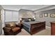 Cozy bedroom featuring a comfortable queen-size bed, a brown chair, and neutral decor at 8582 E 148Th Ln, Thornton, CO 80602