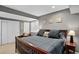 Cozy bedroom with a queen-sized bed, neutral walls, and a private entrance door at 8582 E 148Th Ln, Thornton, CO 80602