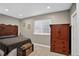 Comfortable bedroom features a carved wood headboard, armoire and a decorative blanket chest at 8582 E 148Th Ln, Thornton, CO 80602