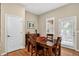 Dining area featuring wood floors, a buffet and backyard access with a door and windows at 8582 E 148Th Ln, Thornton, CO 80602