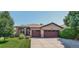 Charming single-story home featuring a well-manicured lawn and a two-car garage at 8582 E 148Th Ln, Thornton, CO 80602