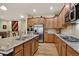 Well-equipped kitchen features wooden cabinets, granite countertops, and stainless steel appliances at 8582 E 148Th Ln, Thornton, CO 80602
