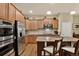 Bright kitchen featuring stainless steel appliances, a breakfast bar and ample cabinet space at 8582 E 148Th Ln, Thornton, CO 80602