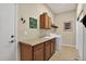 Practical laundry room with tile floors, wooden cabinets and a countertop area at 8582 E 148Th Ln, Thornton, CO 80602