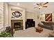 Inviting living room with a fireplace, soft carpet, and stylish decor at 8582 E 148Th Ln, Thornton, CO 80602