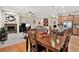 Open-concept design with a fireplace and seamless transition to the dining and kitchen area at 8582 E 148Th Ln, Thornton, CO 80602