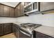 Modern kitchen details: stainless steel appliances, gas range, white subway tile, and dark cabinets at 21185 E 62Nd Ave, Aurora, CO 80019