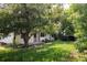 Secluded backyard featuring mature trees and a grassy lawn at 7231 Eaton Cir, Arvada, CO 80003